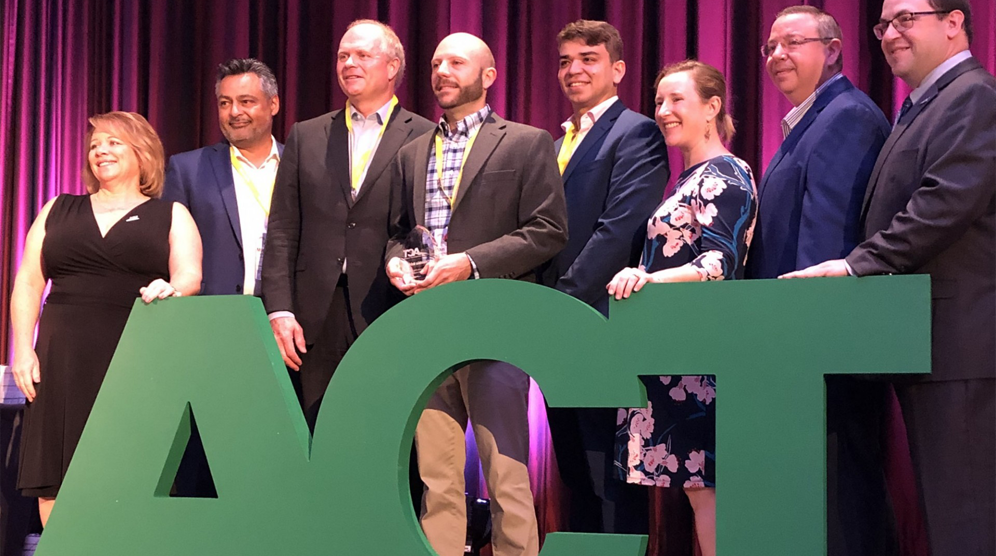 Columbia University representatives from the Transportation and Environmental Stewardship offices accept the award from ACT at the International Conference on August 7, 2019.